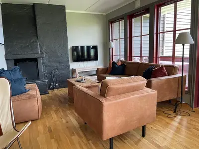a living room with two couches and a fireplace at Charming 2-Bedroom Apartment In Beitostølen in Beitostøl