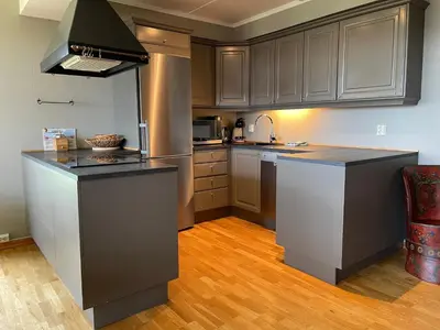 a kitchen with gray cabinets and a counter top at Charming 2-Bedroom Apartment In Beitostølen in Beitostøl