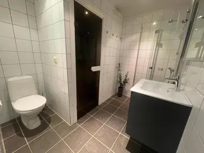 a bathroom with a toilet and a sink and a shower at Charming 2-Bedroom Apartment In Beitostølen in Beitostøl