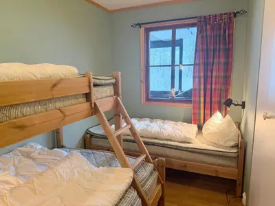 a room with two bunk beds and a window at Central Apartment With Garage, Views, Ski In And Out in Beitostøl