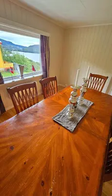 a wooden table with two candles on top of it at Knobelauch Family Home, Valdres in Vøle