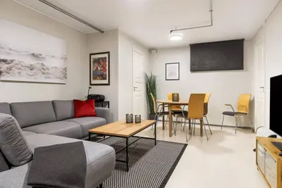 a living room with a couch and a table at 1-roms leiligheter med felles bad, stue og kjøkken in Steinkjer