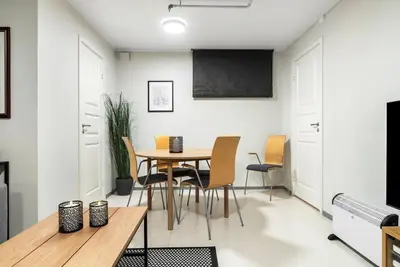 a dining room with a table and chairs at 1-roms leiligheter med felles bad, stue og kjøkken in Steinkjer
