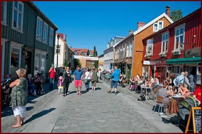 a group of people walking down a street at Nice two-floor home by Gamle bybro in Trondheim