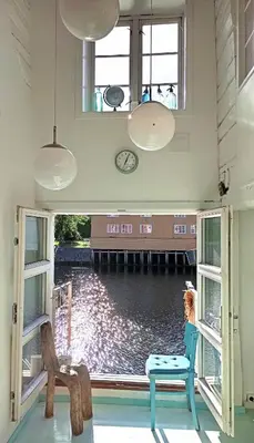 a room with a large window with a view of the water at Nice two-floor home by Gamle bybro in Trondheim