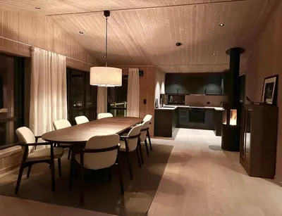 a kitchen and dining room with a table and chairs at Immaculate Cabin in the Heart of Beitostølen in Beitostøl