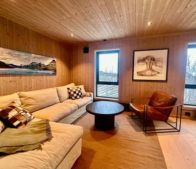 a living room with a couch and a table at Immaculate Cabin in the Heart of Beitostølen in Beitostøl