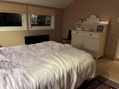 a bedroom with a large white bed and a desk at Large single-family home on Dalgård with walking distance to VM2025 in Trondheim