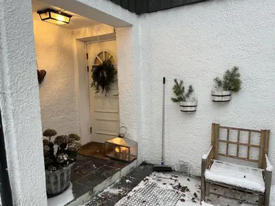 a front door of a house with potted plants at Large single-family home on Dalgård with walking distance to VM2025 in Trondheim