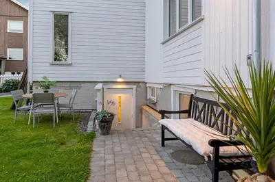 a patio with a bench next to a house at Apartment in Lillehammer in Lillehammer