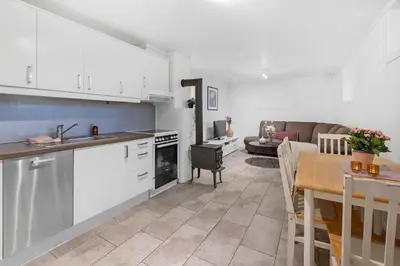 a kitchen and living room with a table and a couch at Apartment in Lillehammer in Lillehammer