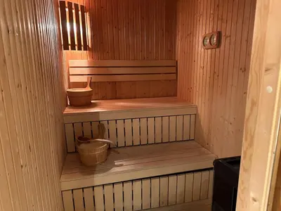 a sauna with three wooden steps and two buckets at Family-Friendly Stay With Stunning Mountain Views! in Beitostøl