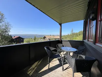 a patio with chairs and a table on a balcony at Family-Friendly Stay With Stunning Mountain Views! in Beitostøl