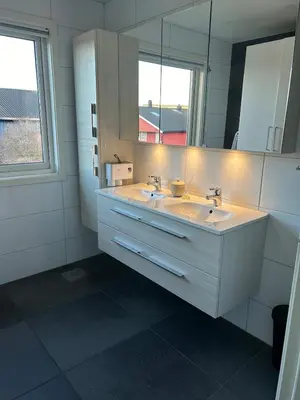 a bathroom with two sinks and a mirror at Horizontal half at Byaasen in Trondheim