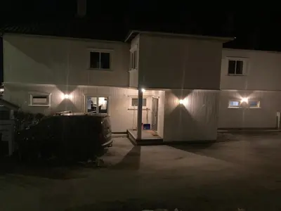 a house with lights on the side of it at night at Trollstova in Sogndal
