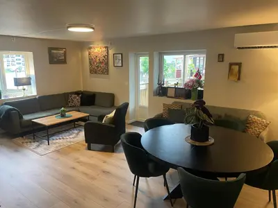 a living room with a couch and a table and chairs at Trollstova in Sogndal