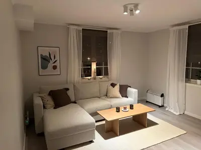 a living room with a couch and a coffee table at Leilighet på Byåsen, i nærheten av Granåsen in Trondheim