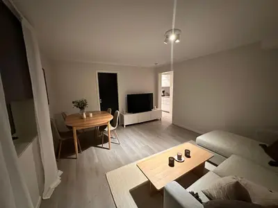 a living room with a couch and a table at Leilighet på Byåsen, i nærheten av Granåsen in Trondheim