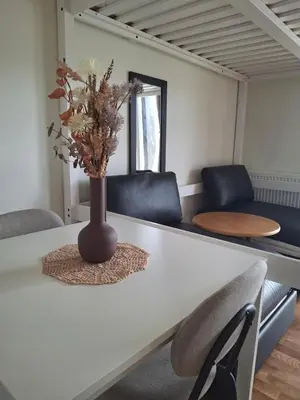 a vase with flowers on a table in a room at Leilighet på Oppheim, Voss in Vossevangen