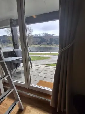 a sliding glass door with a view of a patio at Leilighet på Oppheim, Voss in Vossevangen