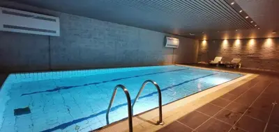 a large swimming pool in a building at Leilighet på Oppheim, Voss in Vossevangen