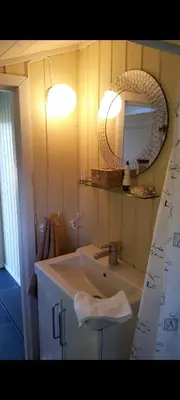 a bathroom with a sink and a mirror at Holiday house by Lake Mjosa, 4 beds in Eidsvoll