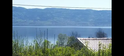 a view of a large body of water with a house at Holiday house by Lake Mjosa, 4 beds in Eidsvoll