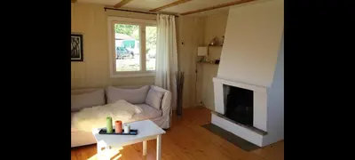 a living room with a couch and a fireplace at Holiday house by Lake Mjosa, 4 beds in Eidsvoll