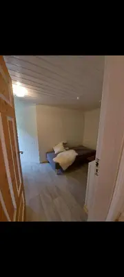 a room with a bed in the middle of a room at Huset med utsikt til innsjøen -8 min til Gjøvik sentrum in Gjøvik