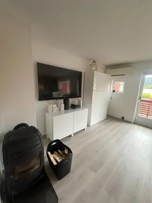 a living room with a flat screen tv on a wall at House near Granåsen Ski Arena in Trondheim