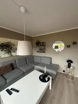 a living room with a couch and a table at House near Granåsen Ski Arena in Trondheim