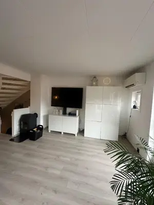 a living room with white cabinets and a flat screen tv at House near Granåsen Ski Arena in Trondheim