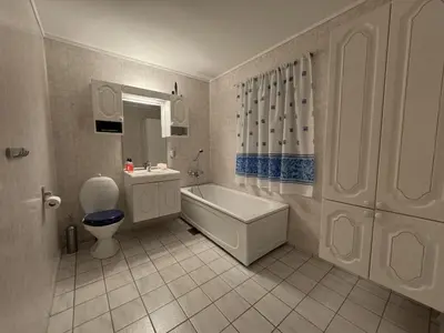 a bathroom with a tub and a toilet and a sink at Modern Home with a View, Easy access to World Ski Championships in Malvik