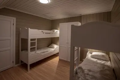 a room with two bunk beds and a bed at Bakkebyvegen 15B in Trysil
