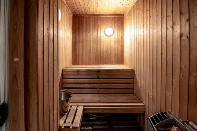 a wooden sauna with a bench in the middle at Bakkebyvegen 15B in Trysil