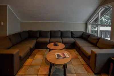 a living room with a couch and a table at Bakkebyvegen 15A in Trysil