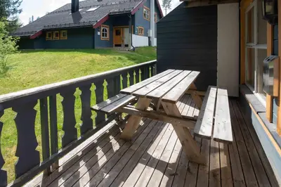 a wooden bench sitting on the porch of a house at Bakkebyvegen 15A in Trysil