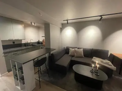 a living room with a couch and a table at Newly renovated apartment in the middle of Trondheim city centre in Trondheim