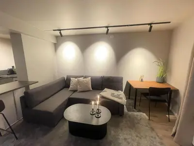 a living room with a couch and a table at Newly renovated apartment in the middle of Trondheim city centre in Trondheim