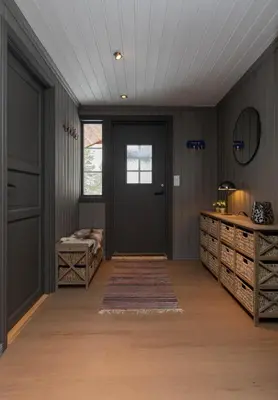 a hallway with a black door and wooden floors at Newly renovated cabin in Nesfjellet, Nesbyen in Nesbyen