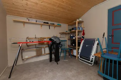a room with a desk and a table with an umbrella at Newly renovated cabin in Nesfjellet, Nesbyen in Nesbyen
