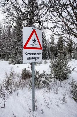 a sign for a crosswalk sign in the snow at Newly renovated cabin in Nesfjellet, Nesbyen in Nesbyen