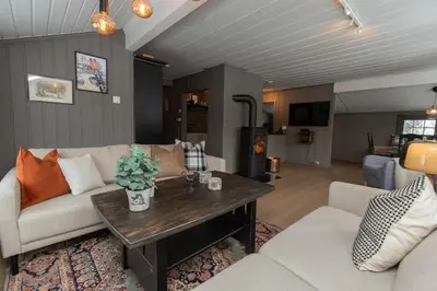 a living room with a couch and a table at Newly renovated cabin in Nesfjellet, Nesbyen in Nesbyen