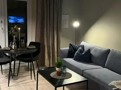 a living room with a couch and a table at Comfort Apartment in Lone Only 20 minutes away from the heart of the city! in Bergen