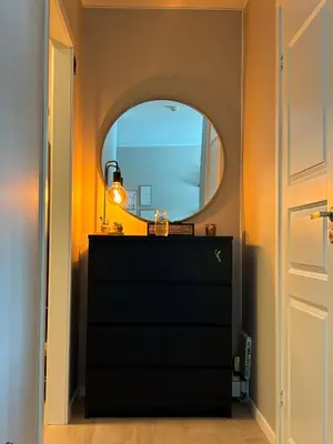 a room with a black dresser and a mirror at Ski VM 2025 in Trondheim