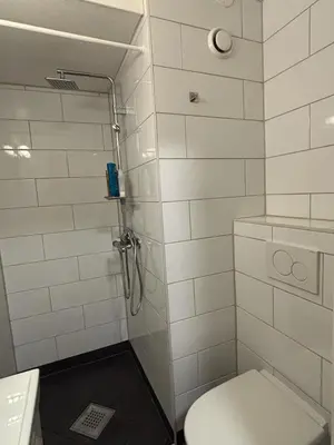 a bathroom with a shower with a toilet and a sink at Ski VM 2025 in Trondheim