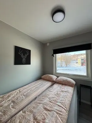 a bedroom with a bed with a large window at Ski VM 2025 in Trondheim