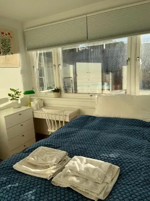 a bedroom with a bed with two towels on it at Top floor, cozy apartment, centrally located in Trondheim in Trondheim
