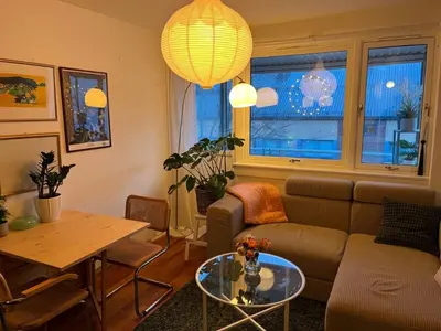 a living room with a couch and a table at Top floor, cozy apartment, centrally located in Trondheim in Trondheim