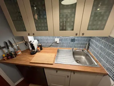a kitchen counter with a sink in a kitchen at Top floor, cozy apartment, centrally located in Trondheim in Trondheim